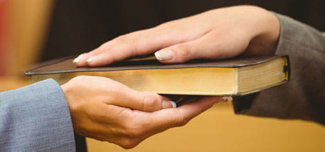 Witness swearing on book in court